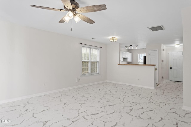 unfurnished living room featuring ceiling fan