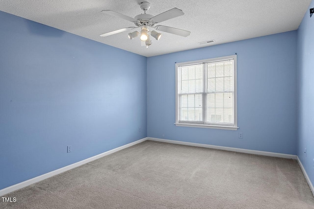 unfurnished room featuring a textured ceiling, carpet floors, and ceiling fan