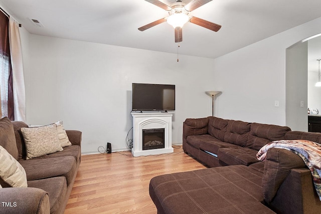 living room featuring ceiling fan and light hardwood / wood-style flooring