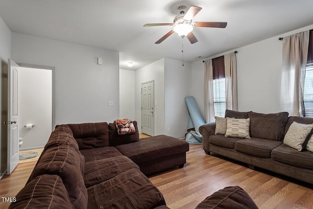 living room with light wood-type flooring and ceiling fan