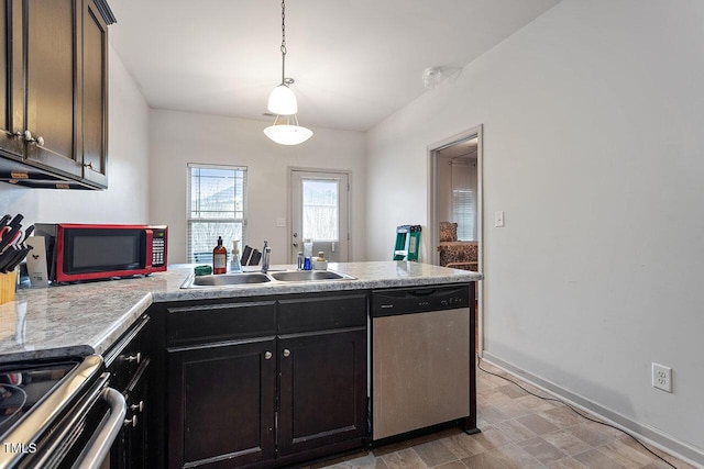 kitchen featuring stainless steel dishwasher, dark brown cabinets, sink, and hanging light fixtures