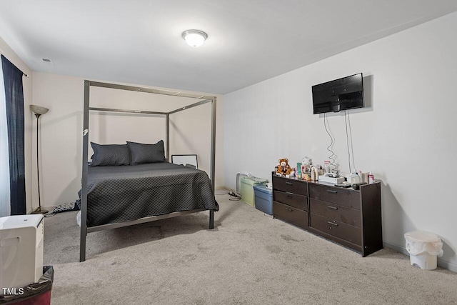 bedroom featuring light carpet