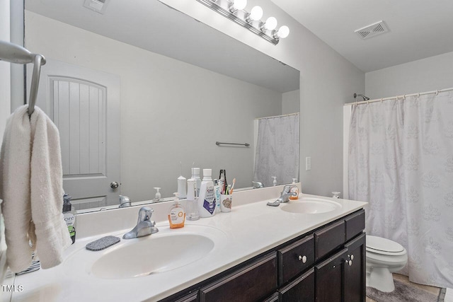 bathroom with vanity, toilet, and walk in shower