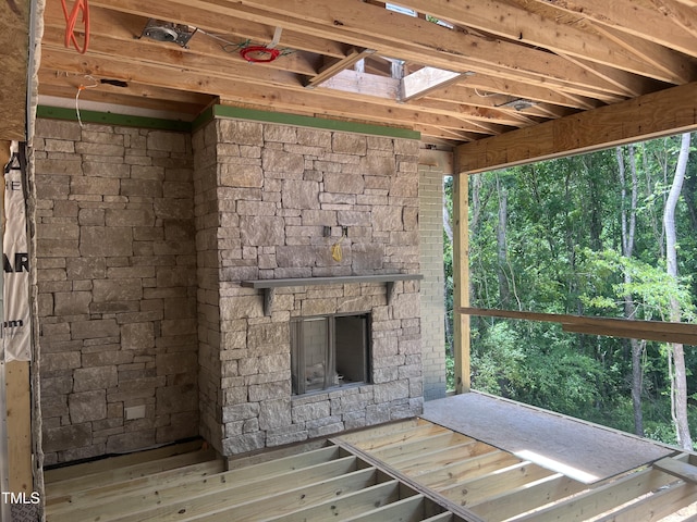 274 Westhampton Dr, Pittsboro, NC 27312 - unfurnished living room with a skylight, an outdoor stone fireplace, and healthy amount of natural light