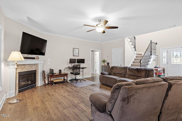 living room with ceiling fan, wood-type flooring, and ornamental molding