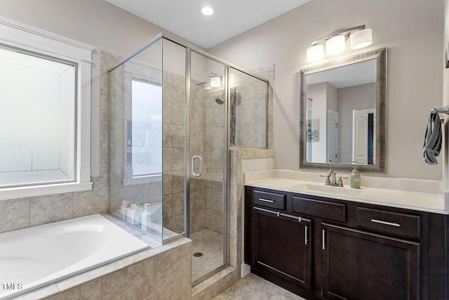 bathroom featuring vanity and separate shower and tub