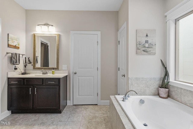 bathroom with vanity, a relaxing tiled tub, and tile patterned floors