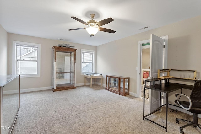 carpeted office with ceiling fan