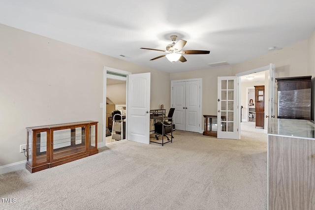 interior space with ceiling fan, french doors, and light colored carpet