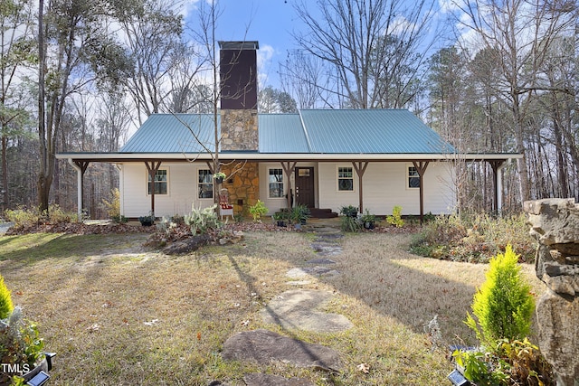 back of property with a yard and a porch