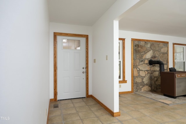 540 Patterson Dr, Chapel Hill, NC 27516 - foyer with baseboards, a wood stove, and visible vents