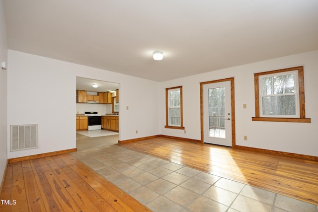 540 Patterson Dr, Chapel Hill, NC 27516 - unfurnished living room with baseboards, light wood-style floors, and visible vents
