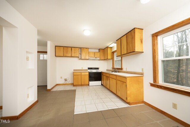 540 Patterson Dr, Chapel Hill, NC 27516 - kitchen with under cabinet range hood, light countertops, baseboards, and electric stove