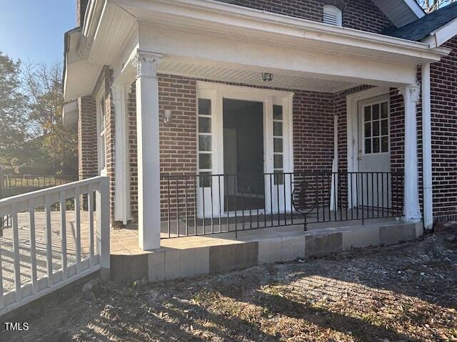 doorway to property featuring covered porch