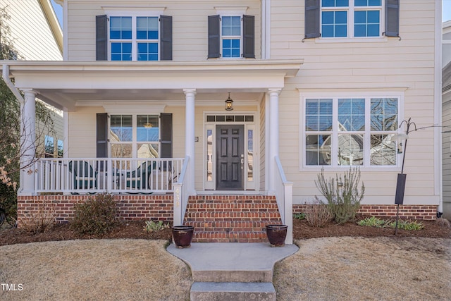 doorway to property with a porch