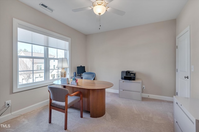 carpeted office space with ceiling fan