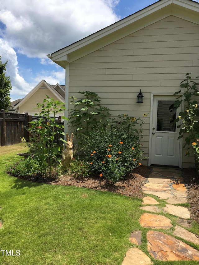 entrance to property featuring a lawn