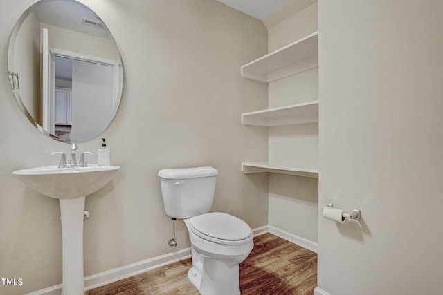 bathroom with wood-type flooring and toilet