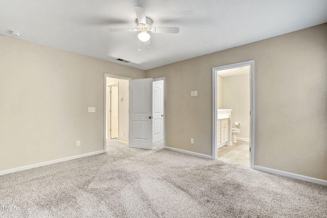 unfurnished bedroom with connected bathroom, light colored carpet, and ceiling fan