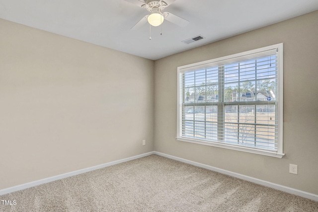 carpeted spare room with ceiling fan