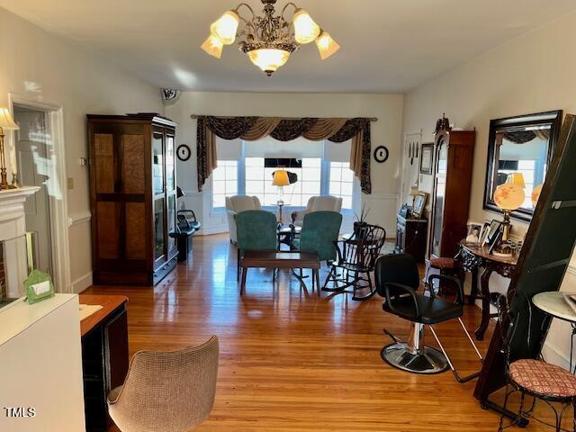 dining area with light hardwood / wood-style flooring and an inviting chandelier