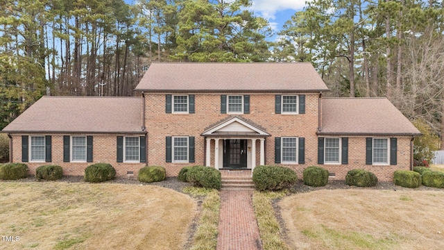 colonial-style house with a front yard