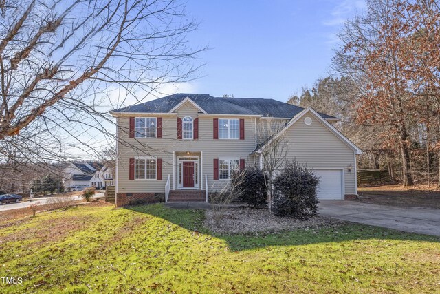 view of front of property featuring a garage and a front lawn