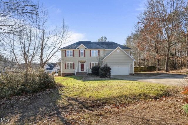 view of front facade featuring a garage and a front lawn