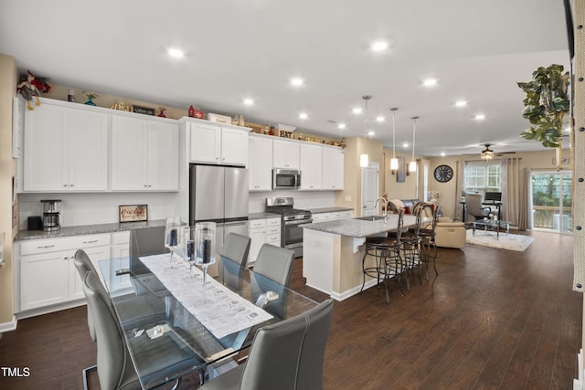 dining room with recessed lighting, dark wood-style flooring, and ceiling fan