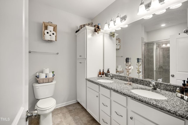 full bathroom featuring a sink, toilet, double vanity, and a shower stall