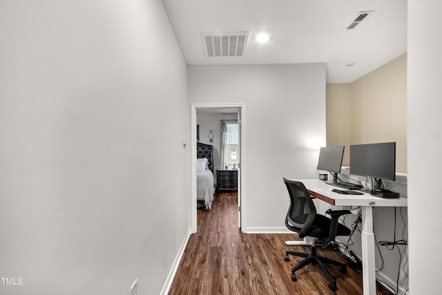 home office featuring visible vents, baseboards, and wood finished floors