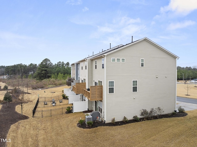 view of side of property with central air condition unit