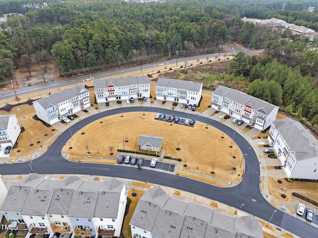 birds eye view of property featuring a forest view