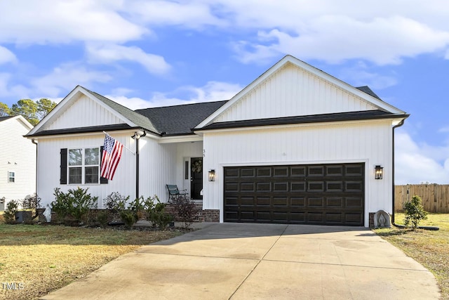 view of front of property featuring a garage and a front lawn