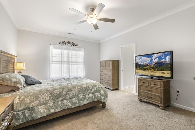 carpeted bedroom with ceiling fan and ornamental molding