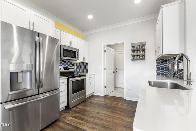 kitchen featuring white cabinetry, sink, stainless steel appliances, tasteful backsplash, and dark hardwood / wood-style floors