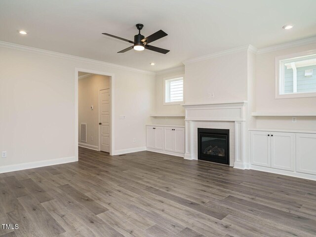 1809 Bright Lantern Way, Wendell, NC 27591 - unfurnished living room with ceiling fan, ornamental molding, wood finished floors, a tile fireplace, and recessed lighting