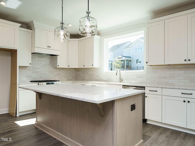1809 Bright Lantern Way, Wendell, NC 27591 - kitchen featuring a kitchen island, dark wood-style floors, white cabinetry, a kitchen breakfast bar, and ornamental molding