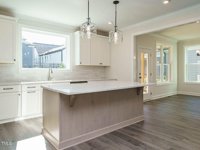 1809 Bright Lantern Way, Wendell, NC 27591 - kitchen with ornamental molding, a center island, white cabinets, backsplash, and a breakfast bar area