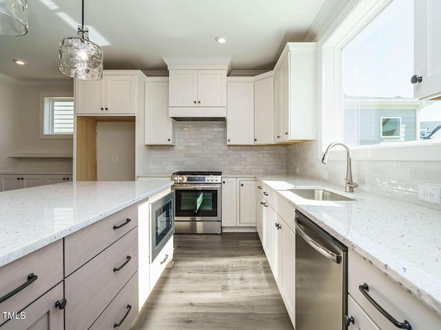 1809 Bright Lantern Way, Wendell, NC 27591 - kitchen with stainless steel appliances, tasteful backsplash, white cabinets, ornamental molding, and light wood-type flooring