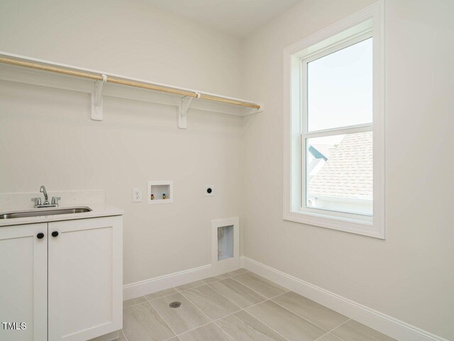 1809 Bright Lantern Way, Wendell, NC 27591 - laundry room featuring hookup for an electric dryer, cabinet space, washer hookup, and light tile patterned floors