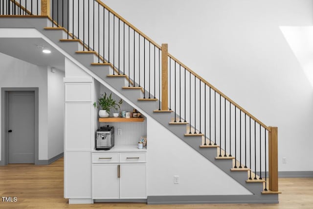 staircase with hardwood / wood-style floors