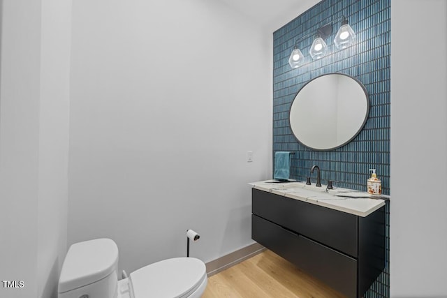 bathroom featuring hardwood / wood-style floors, toilet, and vanity