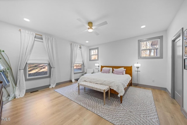 bedroom with ceiling fan and light hardwood / wood-style flooring