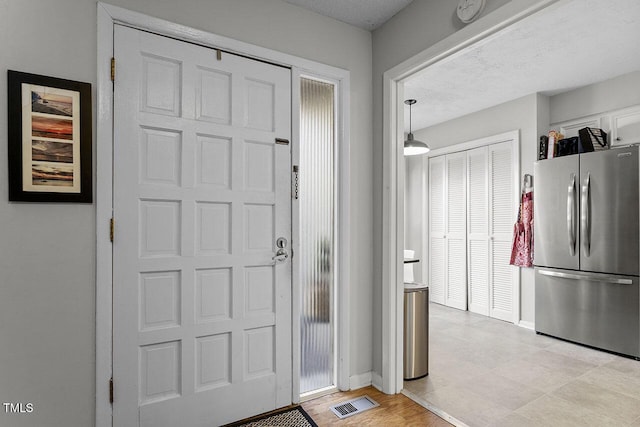 foyer with a textured ceiling