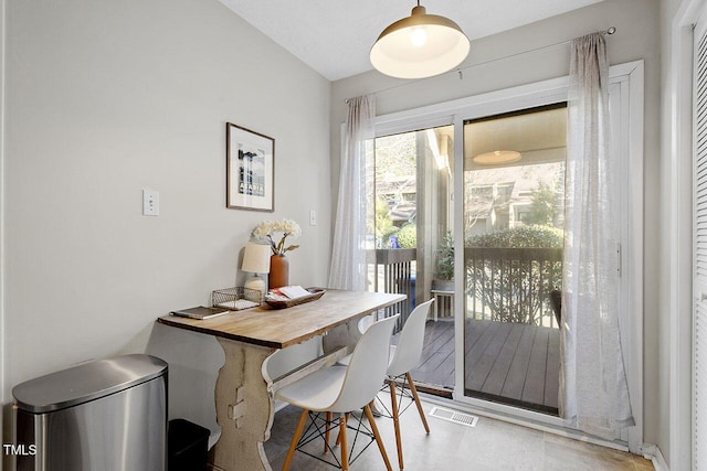 dining room featuring vaulted ceiling