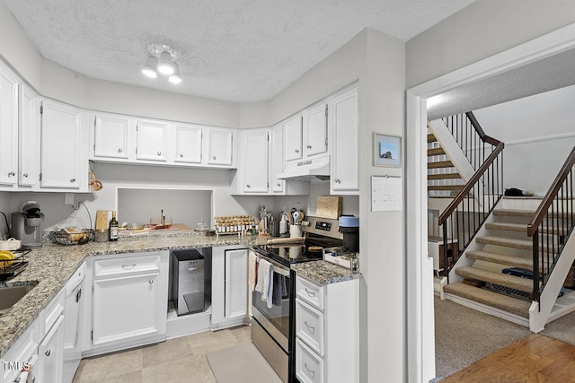 kitchen featuring stainless steel electric range, custom exhaust hood, white cabinets, light stone countertops, and a textured ceiling