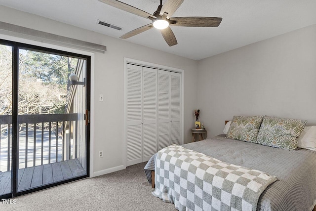 carpeted bedroom featuring access to exterior, ceiling fan, and a closet