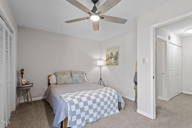 carpeted bedroom with ceiling fan and a textured ceiling