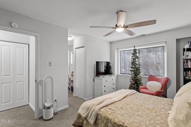 bedroom with light carpet, a textured ceiling, and ceiling fan